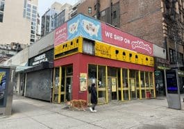 Photo shows Papaya King's red and yellow former storefront.