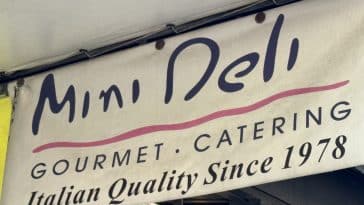 Photo shows a sign for Mini Deli advertising 'Italian Quality Since 1987.'
