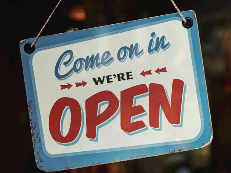 Photo shows a sign reading 'Come on in we're open.'
